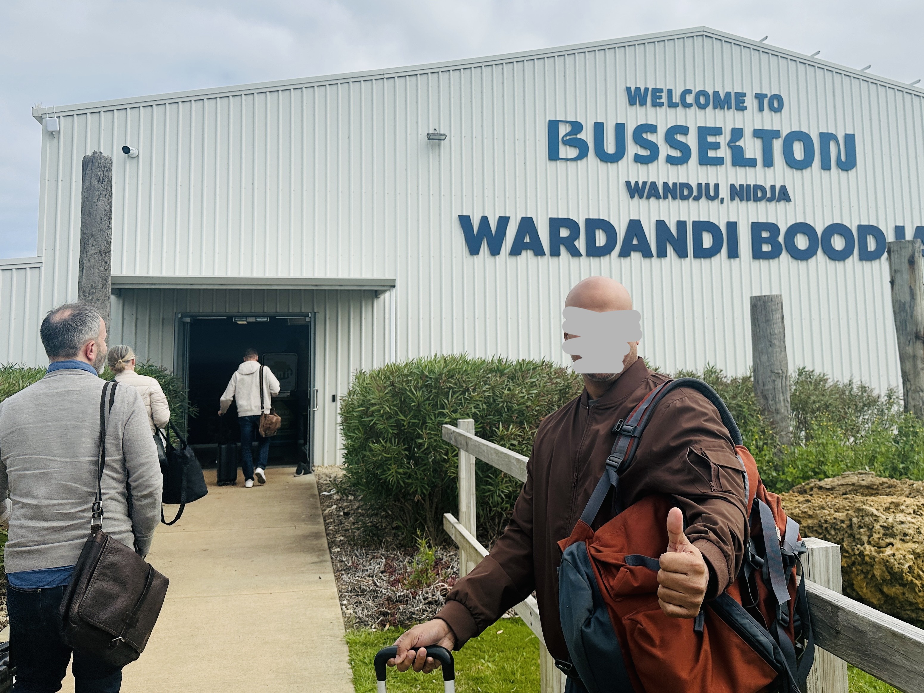 `A` giving a thumbs up outside the Busselton airport